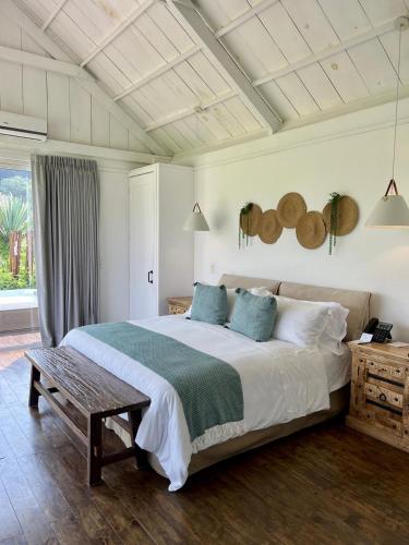 a bedroom with a large bed and a table at Finca San Cayetano in San Juan Alotenango