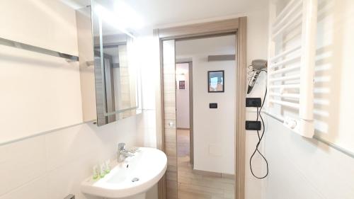 a bathroom with a sink and a mirror and a toilet at Verrazzano Family in Lido di Classe