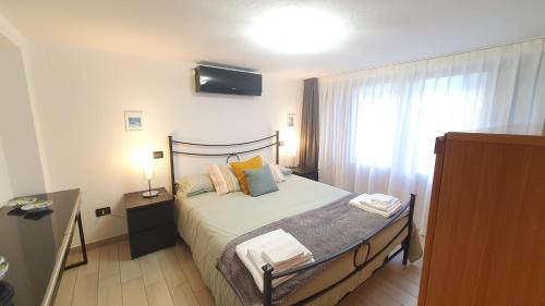 a bedroom with a bed and a window at Verrazzano Family in Lido di Classe