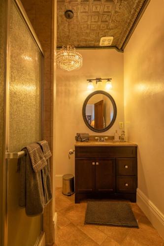 a bathroom with a sink and a mirror at Historic Loft Two 01 in Carson City