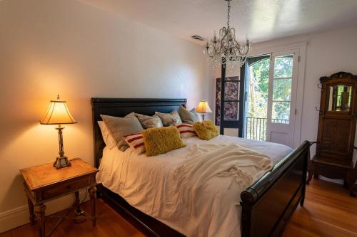 a bedroom with a large bed and a chandelier at Historic Loft Two 01 in Carson City