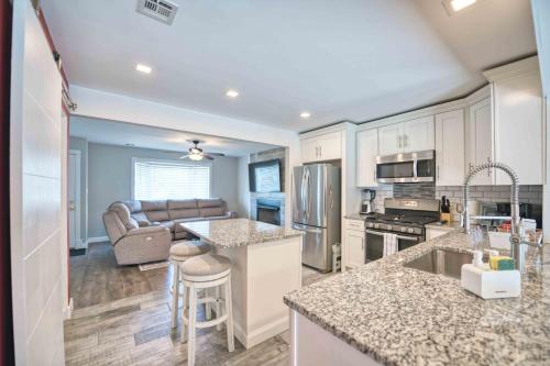 a kitchen with white cabinets and a couch in the background at Waterfront oasis 3BR Game Room Pet Friendly in Little Egg Harbor Township