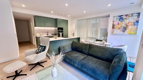 a living room with a couch and a kitchen at Sunshine Place Brent Cross in London