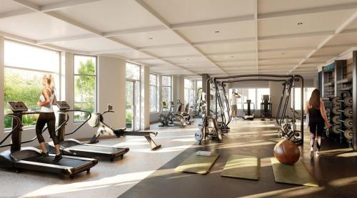 a gym with several treadmills and exercise bikes at Sunshine Place Brent Cross in London