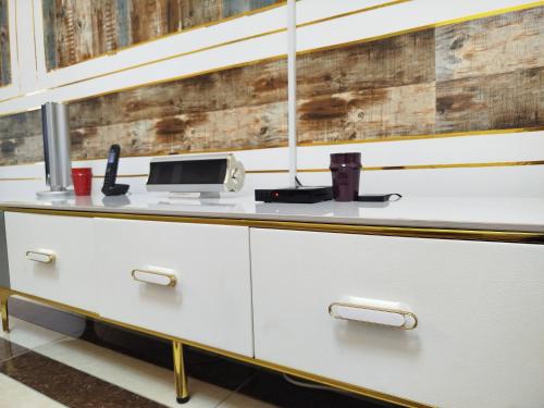 a kitchen with white cabinets and a counter top at Mon Nid d'Or ABIDJAN CI in Abidjan