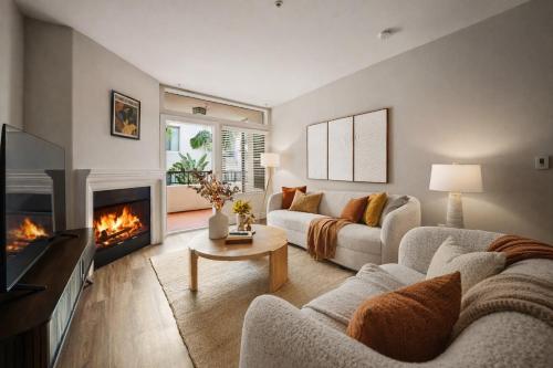 a living room with a couch and a fireplace at Promo Casa Miel Heart of Westwood Luxury Condo in Los Angeles