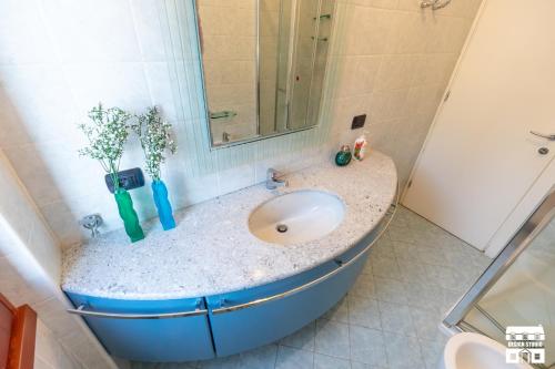 a bathroom with a sink and a mirror at AL LAGO by Design Studio in Bellano