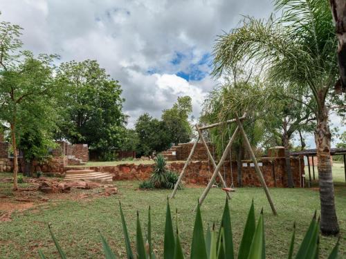 a playground with a swing set in a park at Impala Game Ranch in Dinokeng Game Reserve