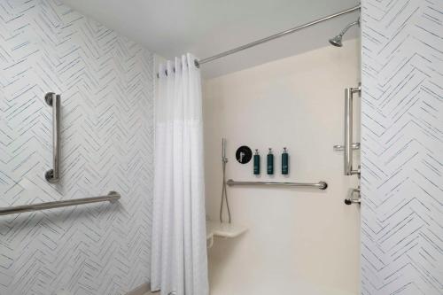 a bathroom with a shower with a shower curtain at DoubleTree by Hilton Hartford Downtown in Hartford
