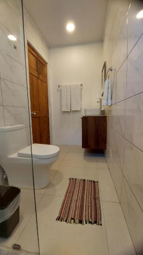 a bathroom with a toilet and a sink at Villas Pura Vida - Marañón in Puntarenas