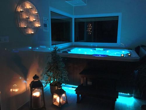 a bathroom with a tub with a christmas tree and lights at La Cachette - Gîte & Hébergements Insolites - Spa in Rivière-sur-Tarn