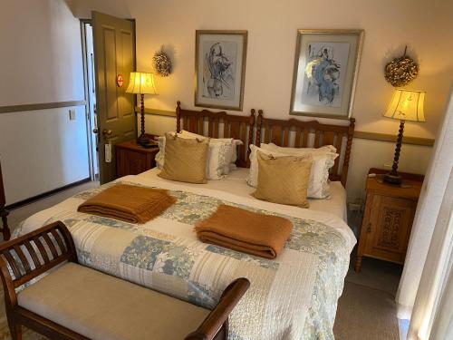 a bedroom with a bed with two towels on it at Periwinkle Blue in Clarens