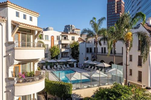 a view of a hotel with a swimming pool and buildings at Promo Casa Miel Heart of Westwood Luxury Condo in Los Angeles