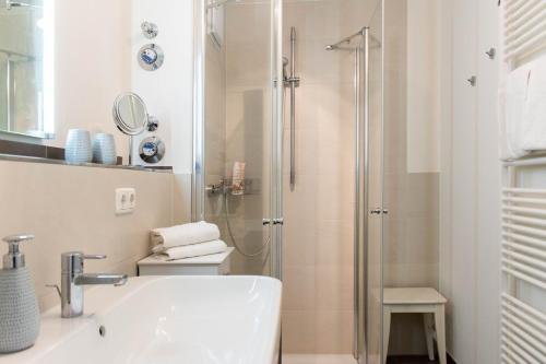 a bathroom with a shower and a sink at Ferienwohnung Dünenhäuser App. A2 in Scharbeutz