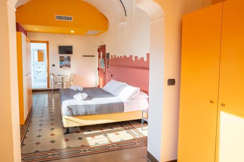 a bedroom with a bed in a room at Hotel Bello by Ostello Bello in Finale Ligure