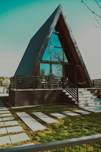 a chapel with a steep roof with a glass window at A frame CHILL House in Brasina
