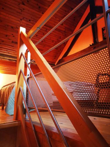 a spiral staircase in a bunk bed room at Les racines Bohèmes in Avèze