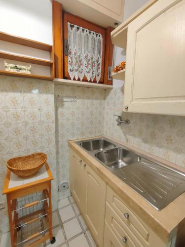 a small kitchen with a sink and a counter at I Tre Archi in Suvereto