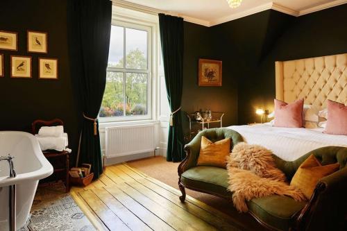 a bedroom with a bed and a chair and a tub at Foyers Lodge in Foyers