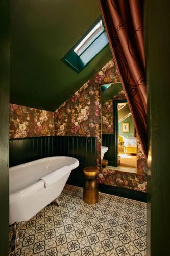 a bathroom with a tub and a large mirror at Foyers Lodge in Foyers