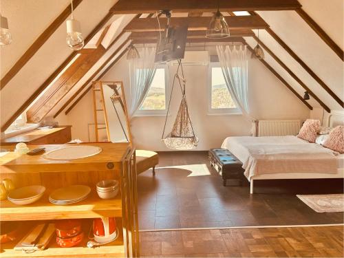 a bedroom with a bed and a sink in a attic at Viktória Inn Tihany in Tihany