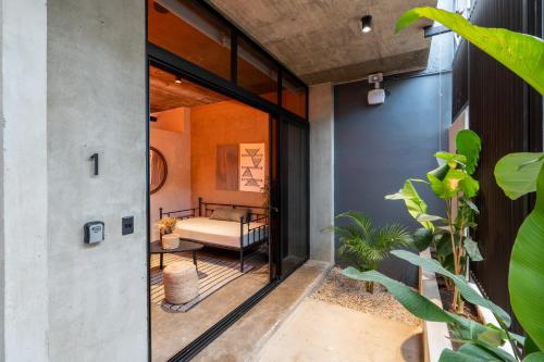 a pivot door opens up to a bedroom in a house at The Sandhaus - Boutique Design Villa with 8 Suites in Jacó