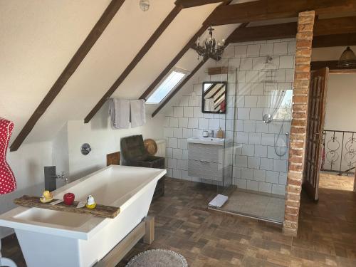 a bathroom with a large tub and a shower at Viktória Inn Tihany in Tihany