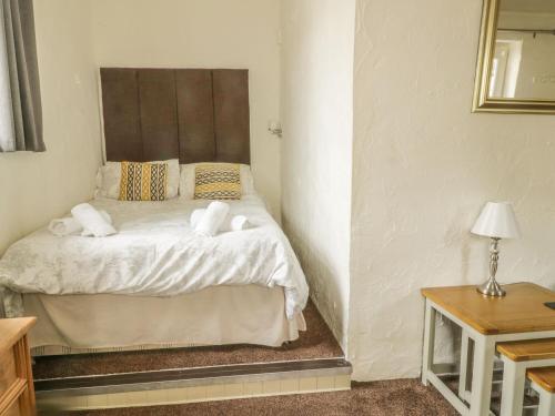 a bedroom with a bed with towels on it at Mews Cottage 7 in Keswick