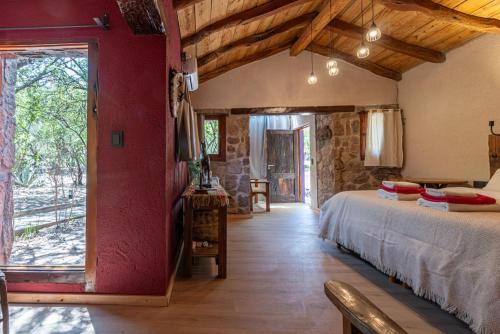 a bedroom with a large bed in a building at Araoz de Lamadrid Wine Lodge in San Javier