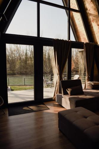 a living room with a couch and a large window at A frame CHILL House in Brasina