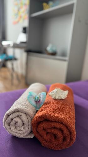 two towels sitting on top of a bed at Sleep&Coffee&Go in Trier