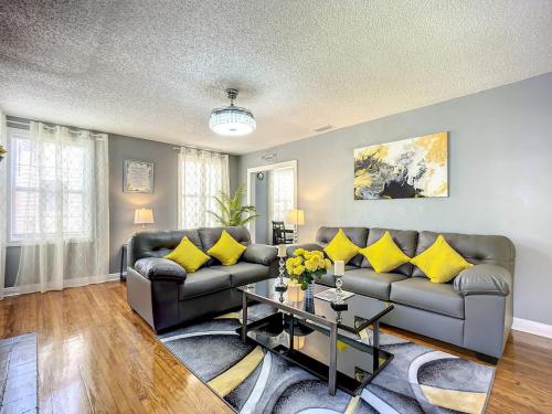 a living room with two couches and a table at Private 2BR 10 Min to Airport & Downtown in Jacksonville