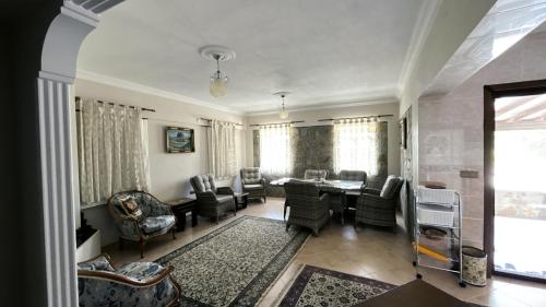 a living room with a dining table and chairs at Bozcaada Bag Evi in Bozcaada