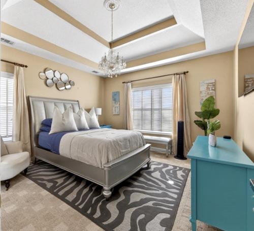 a bedroom with a bed and a blue table at Master Suite with Private Jacuzzi Tub in McDonough