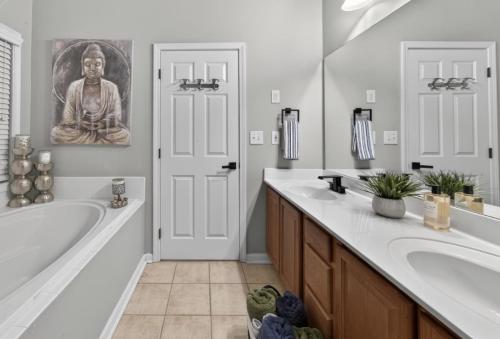 a bathroom with a large tub and a large mirror at Master Suite with Private Jacuzzi Tub in McDonough