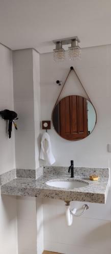 a bathroom with a sink and a mirror at Central Apartment 03 in Ouro Preto
