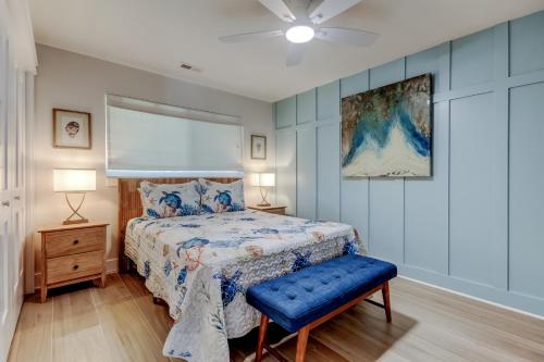 a bedroom with a bed and a blue wall at Indian Rocks Beach West Side Bungalow in Clearwater Beach