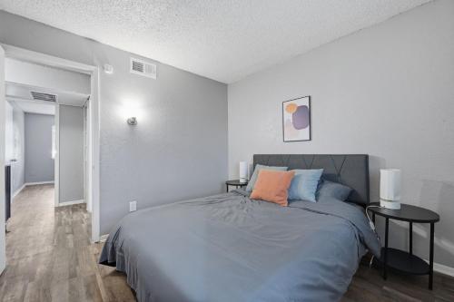 a bedroom with a bed and two end tables at Modern 2BR townhome with full kitchen & dining in Arlington