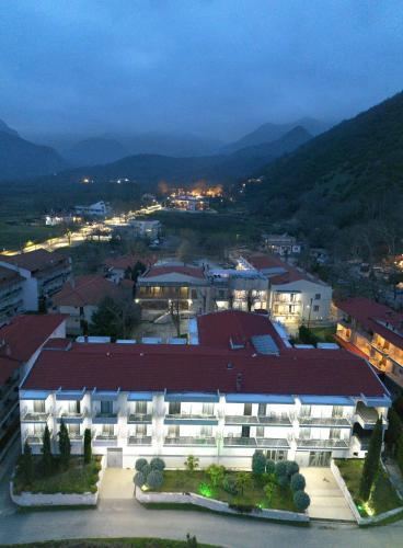 a large building with a red roof in a city at 4 Epoxes Hotel Spa in Kato Loutraki