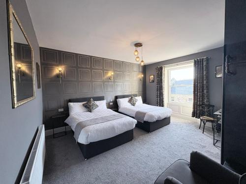 a bedroom with two beds and a window at Crown & Crossed Swords in Shotley Bridge