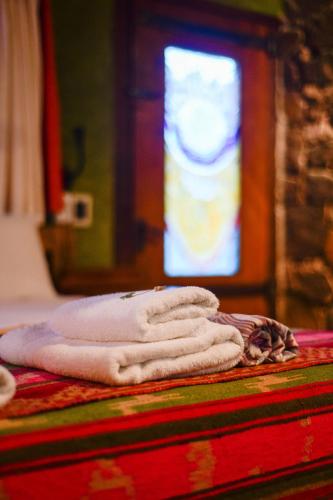 a stack of towels on a table with a stained glass window at Araoz de Lamadrid Wine Lodge in San Javier