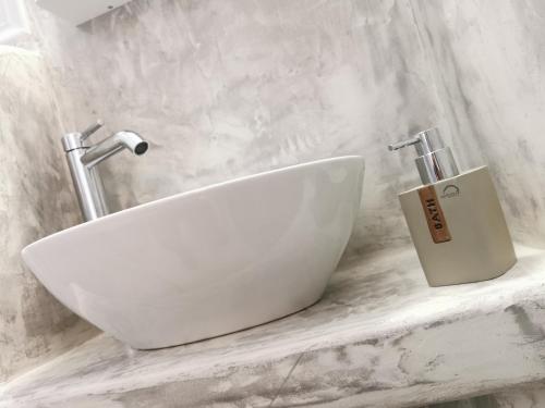 a white sink sitting on a marble counter in a bathroom at Meltemi Chora Amorgos Panoramic View in Amorgos