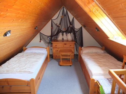 a room with two beds in a attic at Kaptains Koje in Wittmund