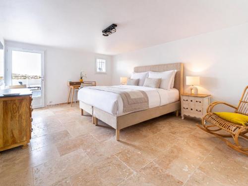 a bedroom with a bed and a table and a chair at Sara in Les Issambres