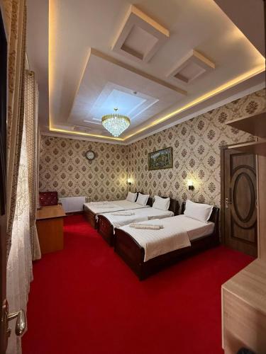 a bedroom with two beds and a red carpet at Зона отдых APACHI в горах ЧИМГАН in Chimgan