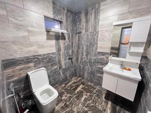 a bathroom with a toilet and a sink at Rest House İsmayıllı Villa in İsmayıllı