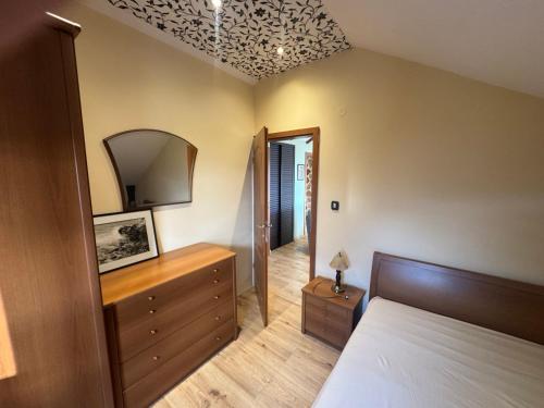 a bedroom with a bed and a dresser and a mirror at Seaview Tivat in Tivat