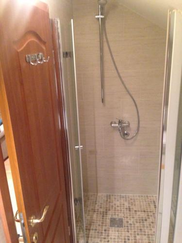 a shower with a glass door in a bathroom at Seaview Tivat in Tivat