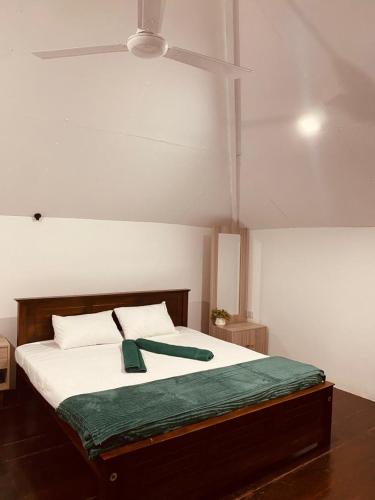 a bedroom with a large bed with a ceiling at Chanco Beach Hotel and Coworking - Negombo in Negombo