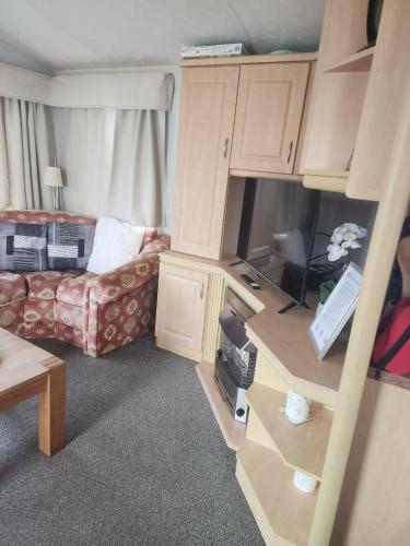 a living room with a couch and a table at 2 Vale Park in Fishguard